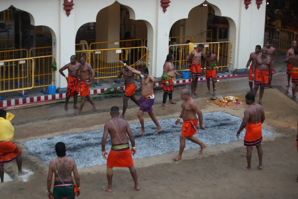 Devotees cross the "carpet" of burning embers during a fire-walking ceremony. The feat is dangerous if walkers do not know what they are doing; the same principle applies to stock investing.