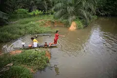 Residents of Buak village in Sanggau regency, Indonesia, use water from the Kadan River for showering and washing clothes. The underpricing of water is one of the factors weakening the investment proposition for the water sector, according to a Global Commission on the Economics of Water report.