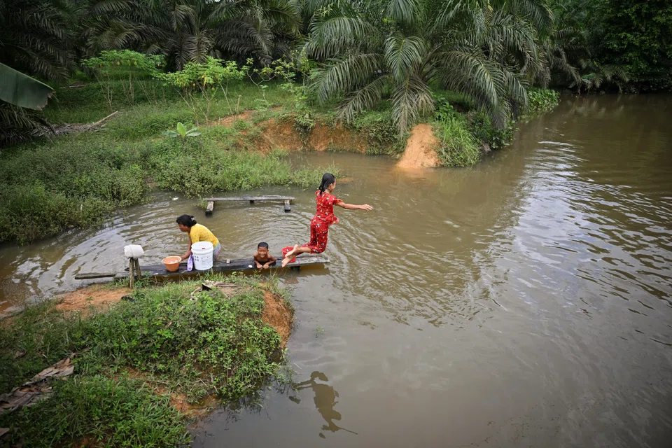 Residents of Buak village in Sanggau regency, Indonesia, use water from the Kadan River for showering and washing clothes. The underpricing of water is one of the factors weakening the investment proposition for the water sector, according to a Global Commission on the Economics of Water report.