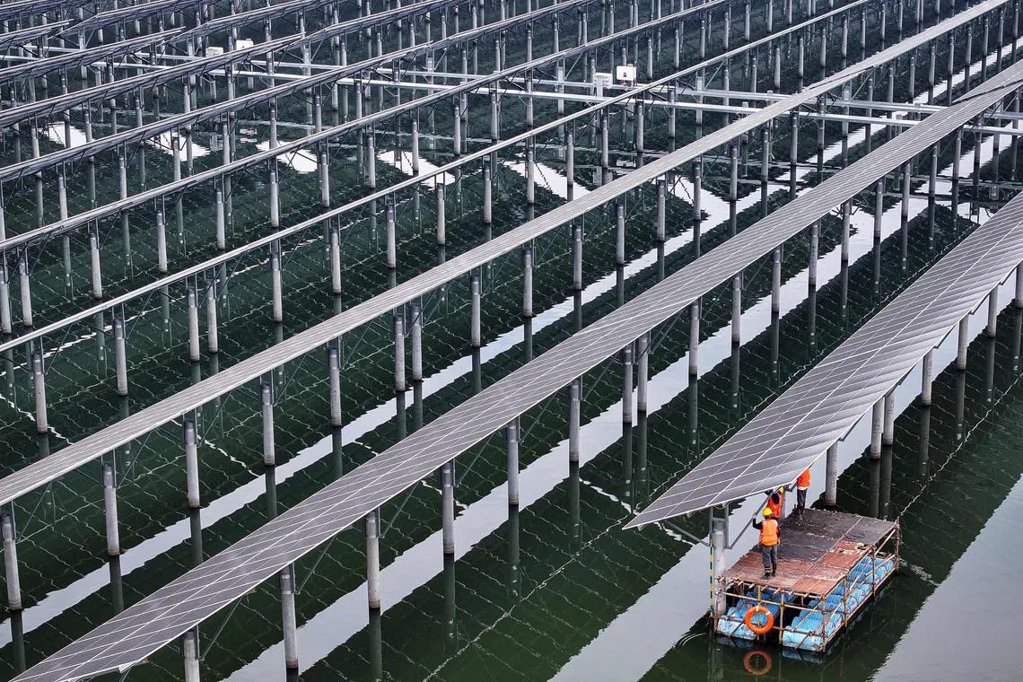 Solar panels at a fishing-solar complementary photovoltaic power generation base in Rudong,  eastern China.  