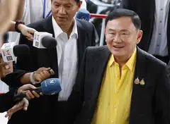 Thaksin, accompanied by his lawyers, went into the court clad in a yellow shirt, a colour that symbolises loyalty to the monarchy.