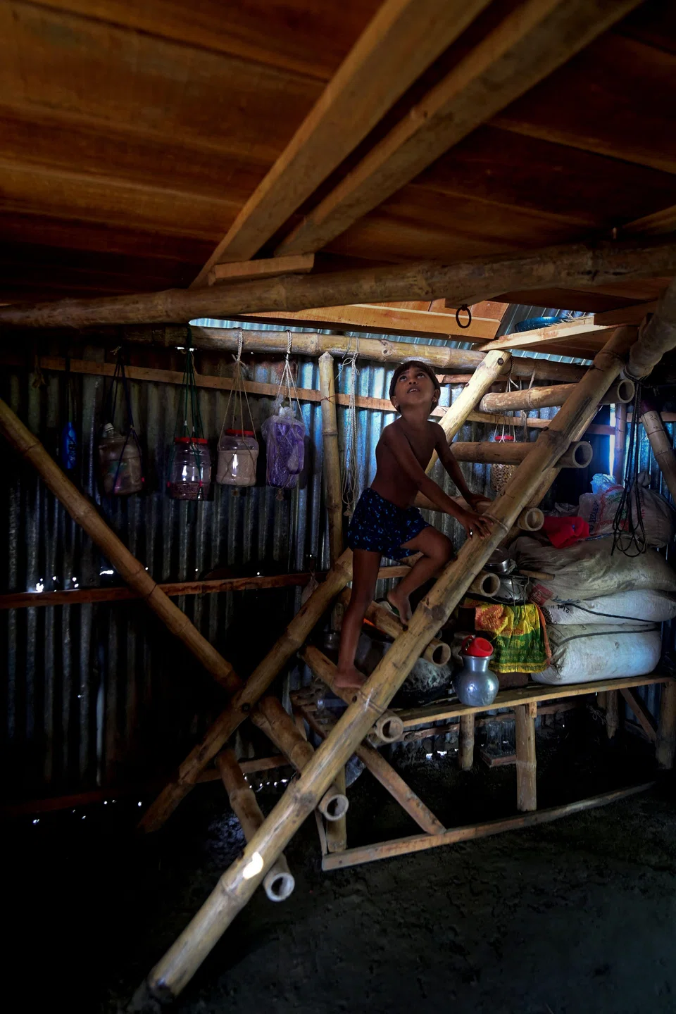 The house is put together using locally available materials by combining bamboo poles and metal sheeting.