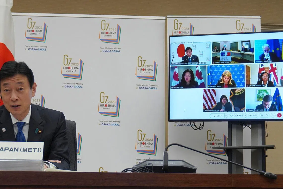 Japan's Economy, Trade and Industry minister Yasutoshi Nishimura (L) speaking in Tokyo at the Apr 4 meeting of the 2023 G7 trade ministers, during which economic security, including export controls, was raised. 