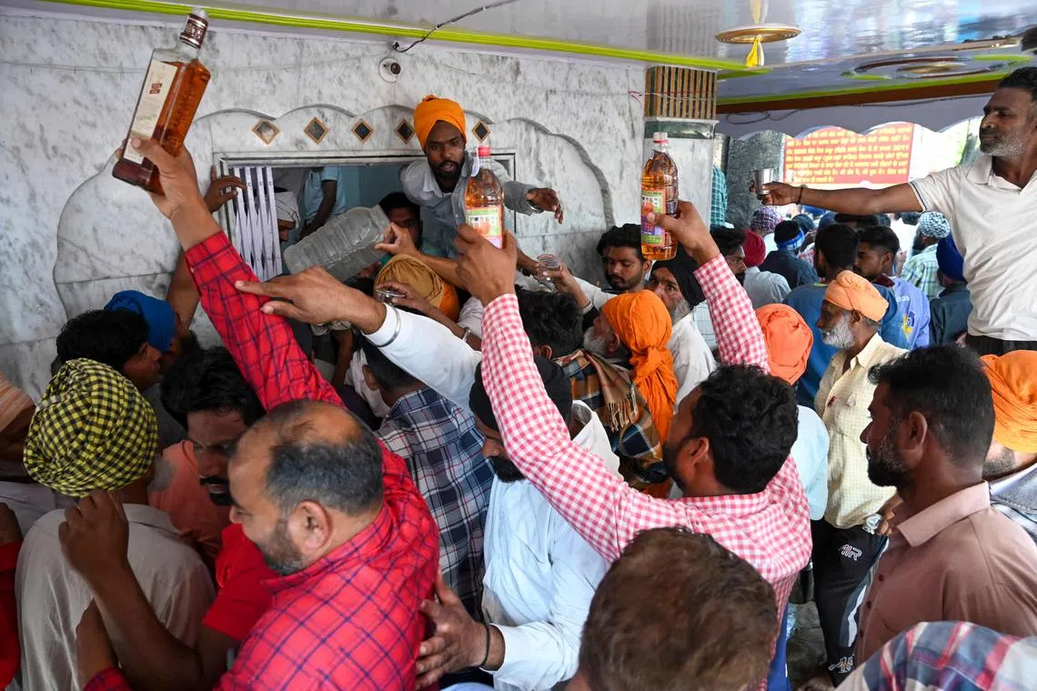 Devotees offer alcoholic beverages during a two-day annual fair at the shrine of Baba Rode Shah in Bhoma village on the outskirts of Amritsar, India, March 2023. According to WHO data, unrecorded alcohol accounts for about 26 per cent of total alcohol consumed in Asia.