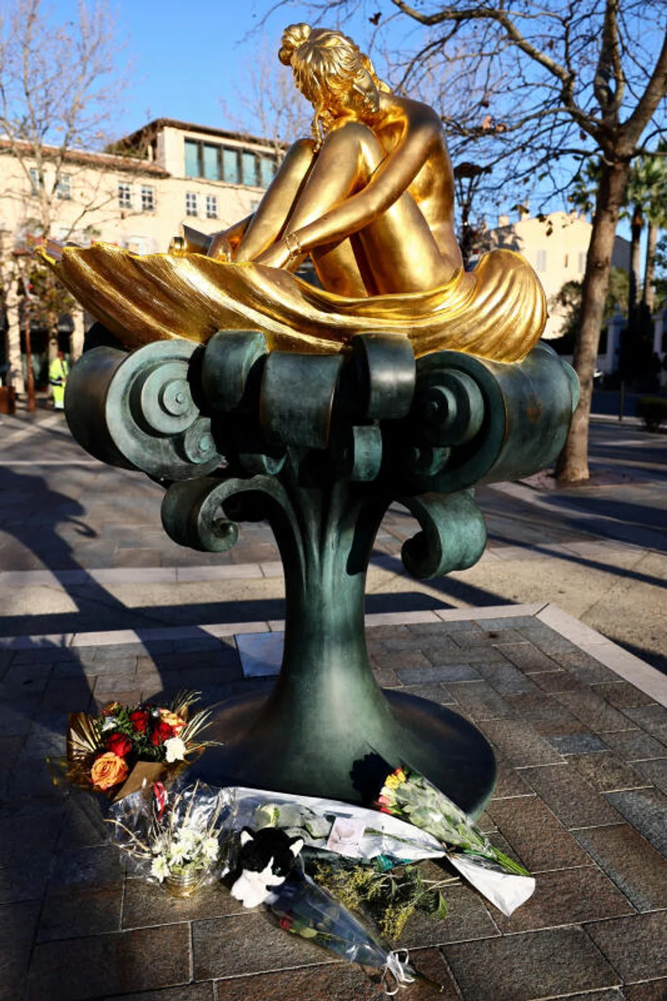 Flower tributes under a statue of the late French singer, actor and animal rights activist Brigitte Bardot.