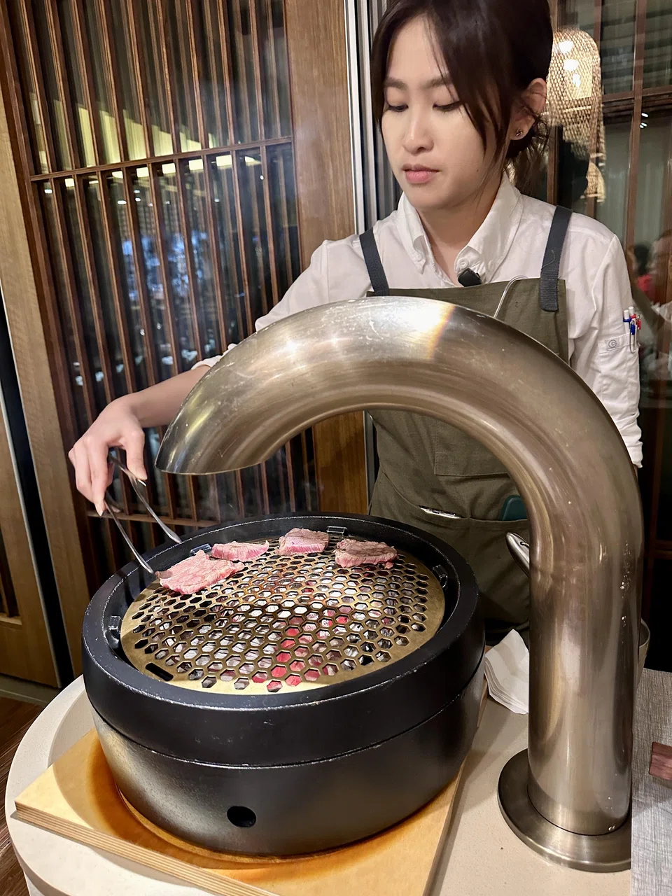 Each table has its own grill and a server to cook the meat.