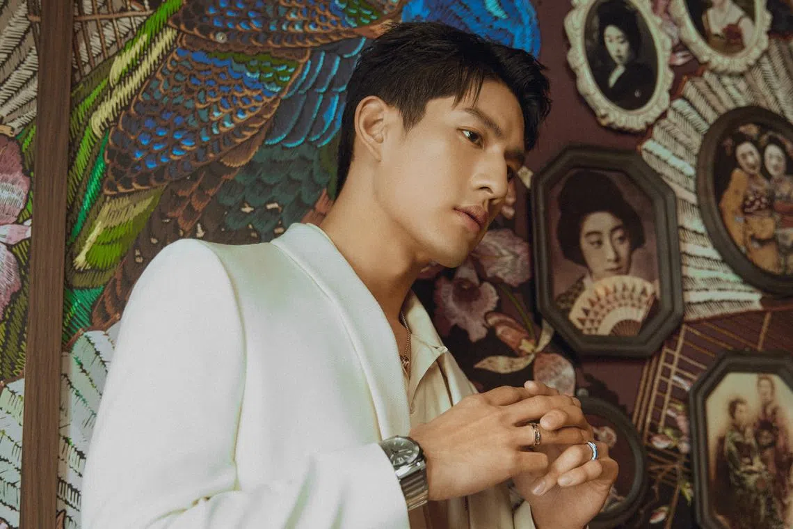 Sng wears a peach shirt and off-white suit by Celine, as well as a  B.Zero1 pendant chain necklace, B.Zero1 rings, B.Zero1 bangle and Octo Finissimo Chronograph GMT watch, all by Bulgari.