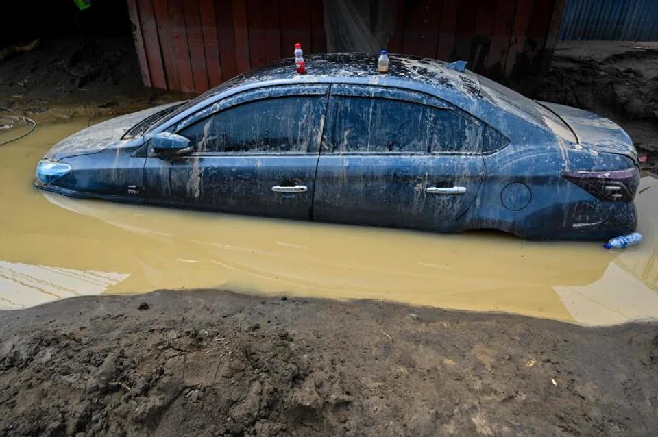 A car trapped in mud after the flash floods in Meureudu, Pidie Jaya district of Indonesia's Aceh province.