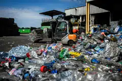 A forklift moves bales of PET plastic bottles before they are recycled at the Plastipak Infineo recycling plant in Saint-Marie-La-Blanche, France, June 1, 2023. In 2019, the world produced around 460 million tonnes of plastic, a figure that has doubled since 2000, according to OECD.