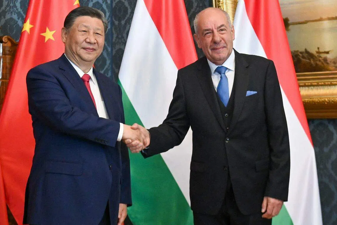 Chinese President Xi Jinping (left) shakes hands with his Hungarian counterpart Tamas Sulyok prior to their official talks in Blue Hall of presidential palace in Budapest, Hungary.