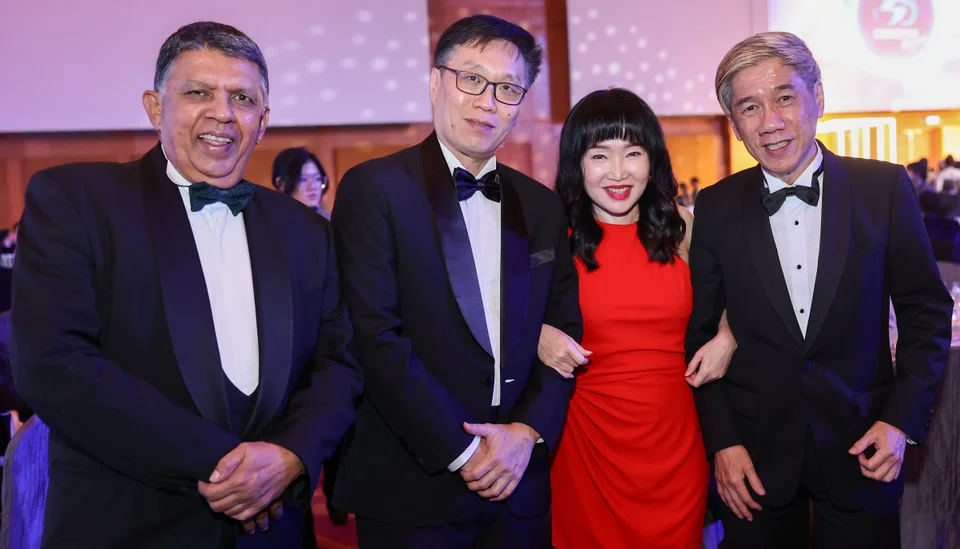 Koh Ching Ching, head of group brand and communications, OCBC (in red), with former editors of The Business Times, from left, Patrick Daniel, Wong Wei Kong (now editor-in-chief, English/ Malay/Tamil Media Group); and Alvin Tay.
