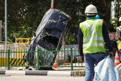 A crane was used to hoist the fallen car out of the sinkhole on Sunday (Jul 27).