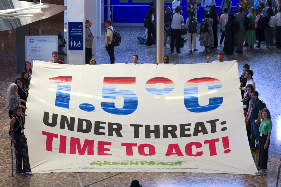 Members of Greenpeace stage a protest during the Climate Change Conference in Bonn, Germany, June 16, 2025. 