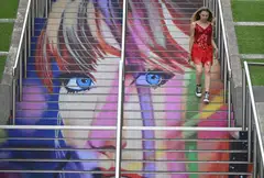 A fan of Taylor Swift using the 'Swiftie Steps' a mural created by the British artist Frank Styles, outside Wembley Stadium in London on Aug 15, ahead of the five concerts she played at the stadium. 