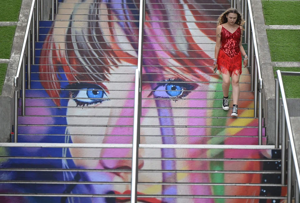 A fan of Taylor Swift using the 'Swiftie Steps' a mural created by the British artist Frank Styles, outside Wembley Stadium in London on Aug 15, ahead of the five concerts she played at the stadium. 