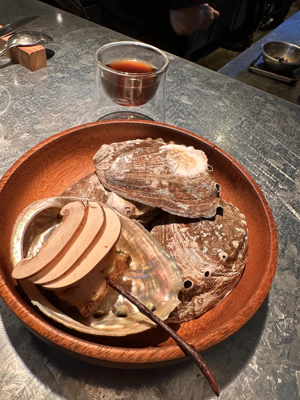 A skewer of 10-hour cooked abalone and king oyster mushroom is chased down with intense mushroom broth.