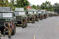 Cambodian soldiers standing next to a convoy of multiple rocket launcher along a street in Preah Vihear province.