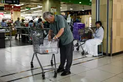 An elderly man packages goods after shopping at a supermarket in Beijing, China, July 9, 2025. China is greying so rapidly that the number of people aged 60 and above is set to hit 400 million by 2035 - roughly equal to the populations of the United States and Italy combined.