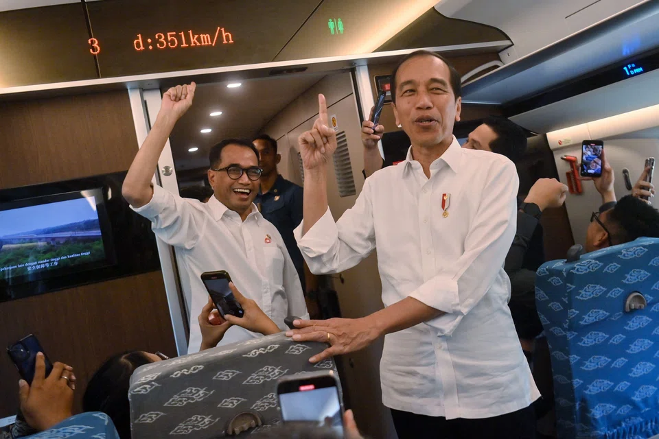 Indonesian President Joko Widodo (right) points towards a display showing the speed during a trial of the new Bandung-Jakarta high-speed train on Sep 13, 2023.