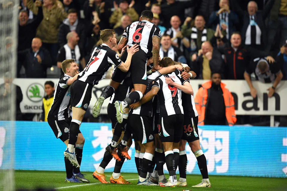  Newcastle United's players celebrating after their team's  opening goal during the English Premier League football match with Arsenal at St James' Park on May 16. The league’s 20 teams play a total of 380 matches each season.