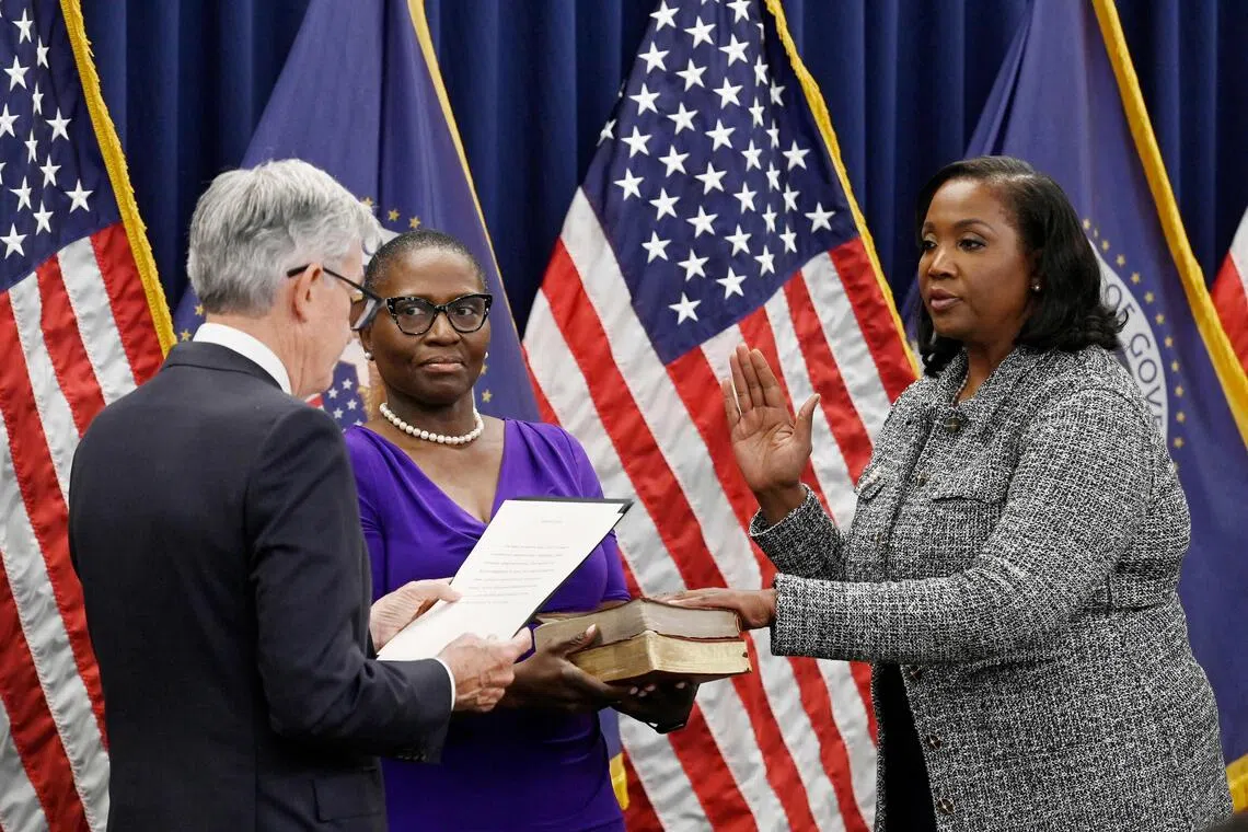 (FILES) Lisa Cook (R) takes the oath of office as she is sworn-in to become a member of the Federal Reserve Board by Federal Reserve Board Chair Jerome Powell, at the Federal Reserve Building in Washington, DC, on May 23, 2022. US Federal Reserve Governor Lisa Cook filed a lawsuit on August 28, 2025, to challenge Donald Trump's move to fire her -- as the president intensified pressure on the independent central bank.  Cook also asked for a temporary restraining order declaring that Trump's attempt to fire her is unlawful and preventing the Fed from removing her for now. A hearing on that motion has been set for August 29. Trump had published a letter on his Truth Social platform on August 25, stating that he was removing Cook from her role and citing accusations of false statements on her mortgage agreements. (Photo by OLIVIER DOULIERY / AFP)