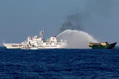 Chinese Coast Guard vessels fire water cannons towards a Philippine resupply vessel Unaizah on May 4 as it made its way to the Second Thomas Shoal in the South China Sea.