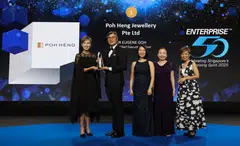 Minister Josephine Teo (left) gives out the top accolade to Poh Heng Jewellery group CEO Eugene Goh (second from left).