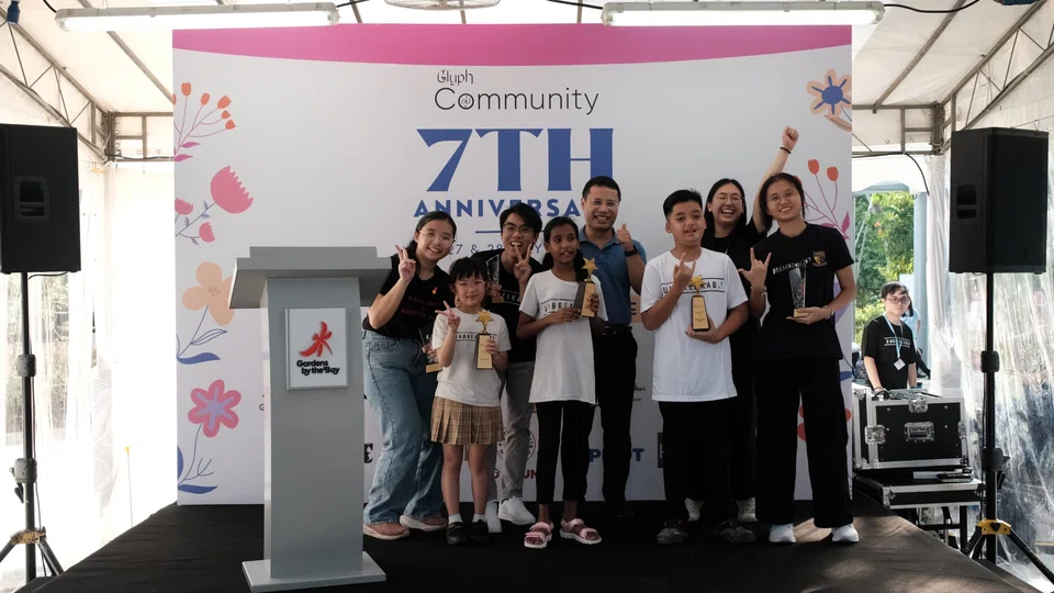 Minister for National Development of Singapore Desmond Lee (centre) with Glyph beneficiaries and volunteers as they celebrate the charity's seventh anniversary.