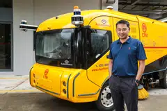 Dr Ang is pictured with Chye Thiam's driverless road sweeper vehicle. With a PhD in engineering, as well as experience in the built environment sector, he hopes to tackle municipal issues.