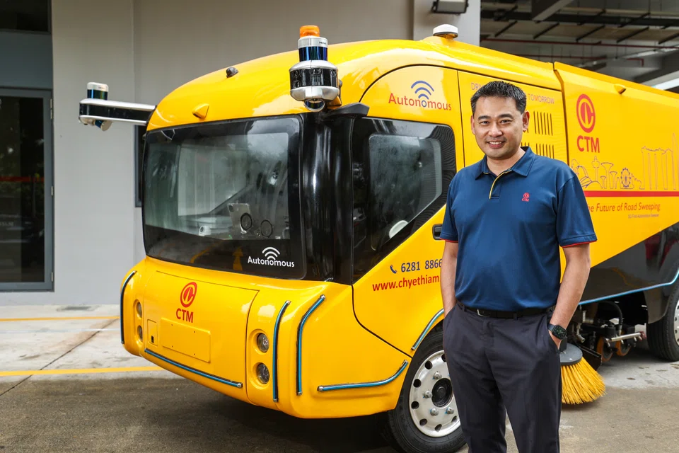 Dr Ang is pictured with Chye Thiam's driverless road sweeper vehicle. With a PhD in engineering, as well as experience in the built environment sector, he hopes to tackle municipal issues.