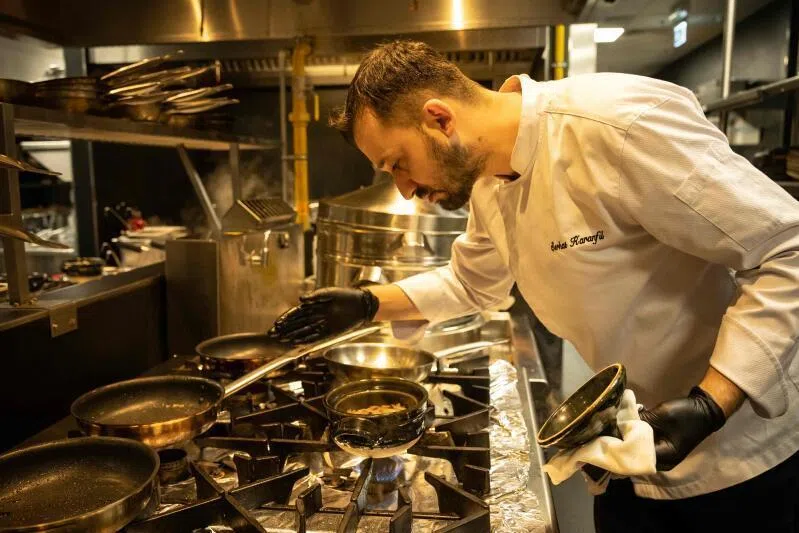 Turkish chef Serhat Karanfil works in the kitchen of Woohoo, an AI-powered restaurant in Dubai. 