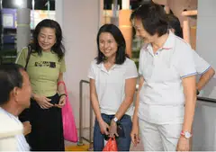 Former MDDI director Goh Hanyan (centre), accompanied by former Nee Soon South MP Lee Bee Wah (right), greeting residents before a Meet-the-People session at the PAP’s Nee Soon Central branch on April 7.