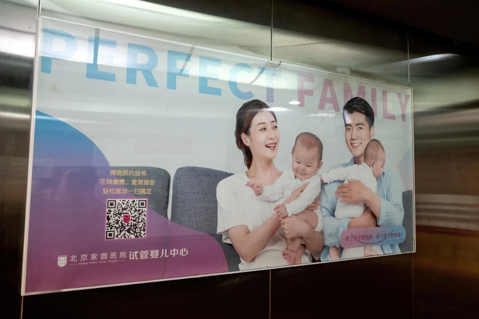An advertisement featuring an image of a family, in an elevator at Beijing Perfect Family Hospital. With fewer babies and more deaths, policymakers are facing a demographic crisis in the making. 