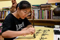 Huyen, 35, takes weekly calligraphy classes alongside six others at her teacher’s tiny home as “a way to relax after work”.