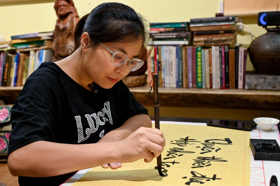 Huyen, 35, takes weekly calligraphy classes alongside six others at her teacher’s tiny home as “a way to relax after work”.