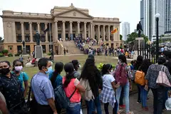 People line up to visit the presidential secretariat in Colombo on July 11, 2022, after it was overrun by anti-government protestors. 