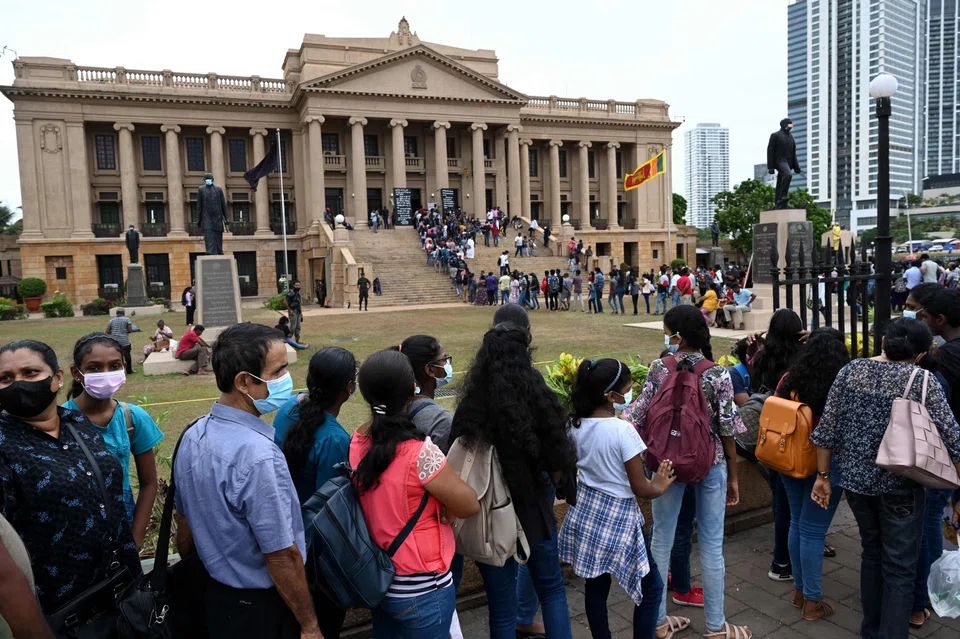 People line up to visit the presidential secretariat in Colombo on July 11, 2022, after it was overrun by anti-government protestors. 