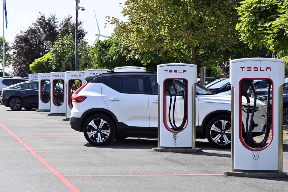 A Tesla electric vehicle charges at a station in Nivelles, Belgium, Aug 26, 2024.  Improvements in the Belgian, Dutch and French EV markets failed to offset a drop of almost 37 per cent in Germany’s battery-electric sales, the European Automobile Manufacturers Association said.