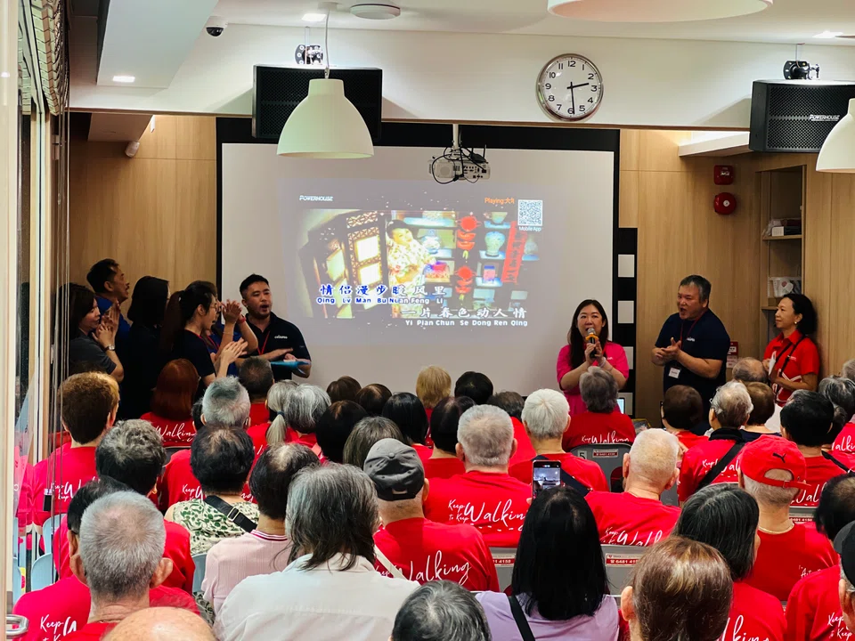 The seniors at Touch's Active Ageing Centre in Yishun singing together at LHN's and Touch's Chinese New Year event on Friday.