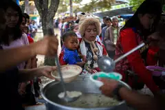 Displaced people queue for food at a school turned temporary shelter, amid clashes between Thailand and Cambodia along a disputed border area in Surin province, Thailand.