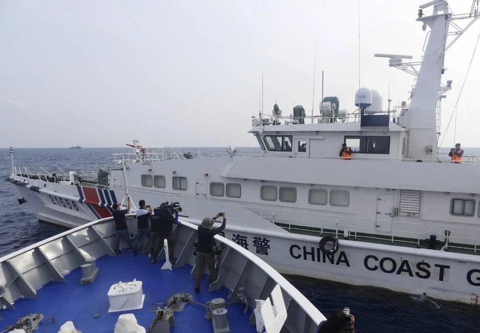 A Chinese coast guard ship maneuvering next to the Philippine coast guard patrol ship BRP Sindangan in the disputed South China Sea on Oct 4, 2023. Beijing claims almost the entire South China Sea and has ignored an international tribunal ruling that its assertions have no legal basis.