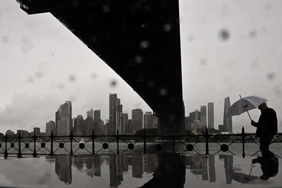 A man walks through the rain at Milsons Point in Sydney, Australia, May 22, 2025. The weather system is now moving south with heavy rains in Sydney on Friday. 