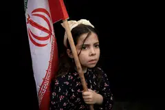 A girl holds an Iranian flag during a protest on Friday (Apr 10) against the direct negotiation between the Israel and Lebanese government, in Beirut, Lebanon.