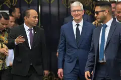 Apple CEO Tim Cook (centre) walks with Indonesian Minister of Communication and Information Budi Arie Setiadi (left) to meet journalists after his meeting with Indonesia's President Joko Widodo at the Merdeka Palace in Jakarta on April 17, 2024. 