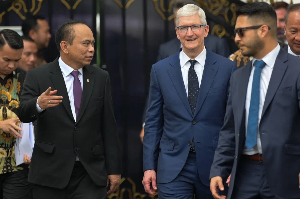 Apple CEO Tim Cook (centre) walks with Indonesian Minister of Communication and Information Budi Arie Setiadi (left) to meet journalists after his meeting with Indonesia's President Joko Widodo at the Merdeka Palace in Jakarta on April 17, 2024. 