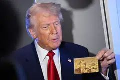Holding a prototype that bore his face and an inscription “The Trump Card”, President Trump said that the special visa would probably be available “in less than two weeks”.