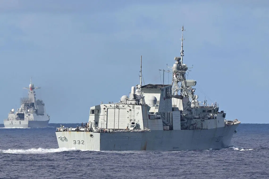 The Royal Canadian Navy frigate HMCS Ville de Quebec (right) is seen in front of a monitoring Chinese PLA Navy vessel (left) during a maritime cooperative activity between the Philippines, Australia and Canadian navies near Scarborough Shoal in disputed waters of the South China Sea on Sep 3, 2025. 