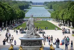 The grandstands for the Olympics' equestrian events are visible in the distance, on the grounds of the Palace of Versailles in Paris.