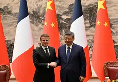 France’s President Emmanuel Macron (left) and China’s President Xi Jinping (right) shake hands after a joint press conference at the Great Hall of the People in Beijing on Dec 4.
