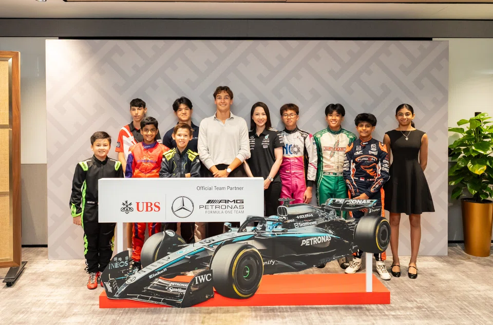 George Russell (in white) of Mercedes together with UBS Singapore country head Young Jin Yee (fifth from right) and some of Singapore's young aspiring F1 drivers. 